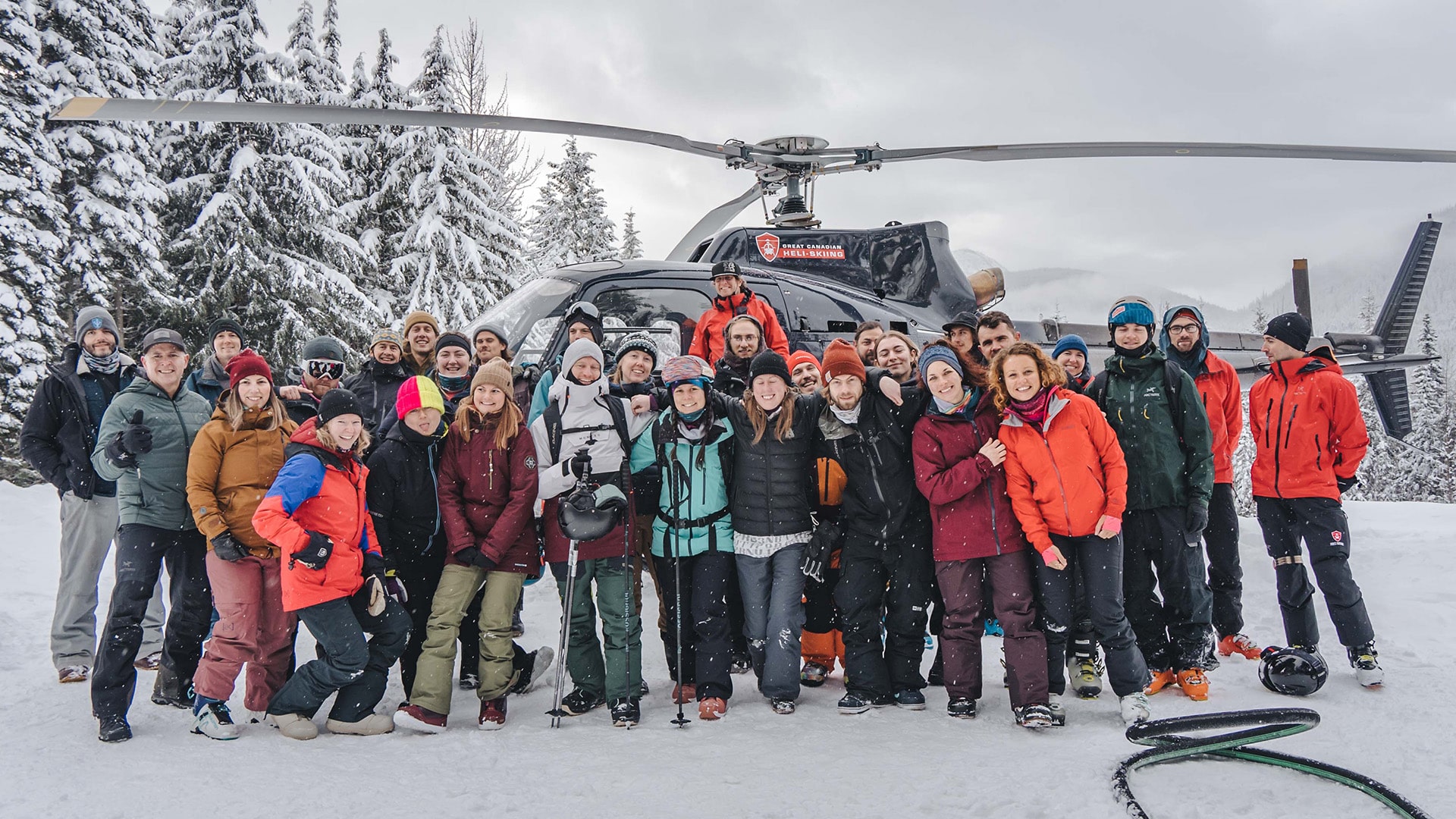 team in front of helicopter